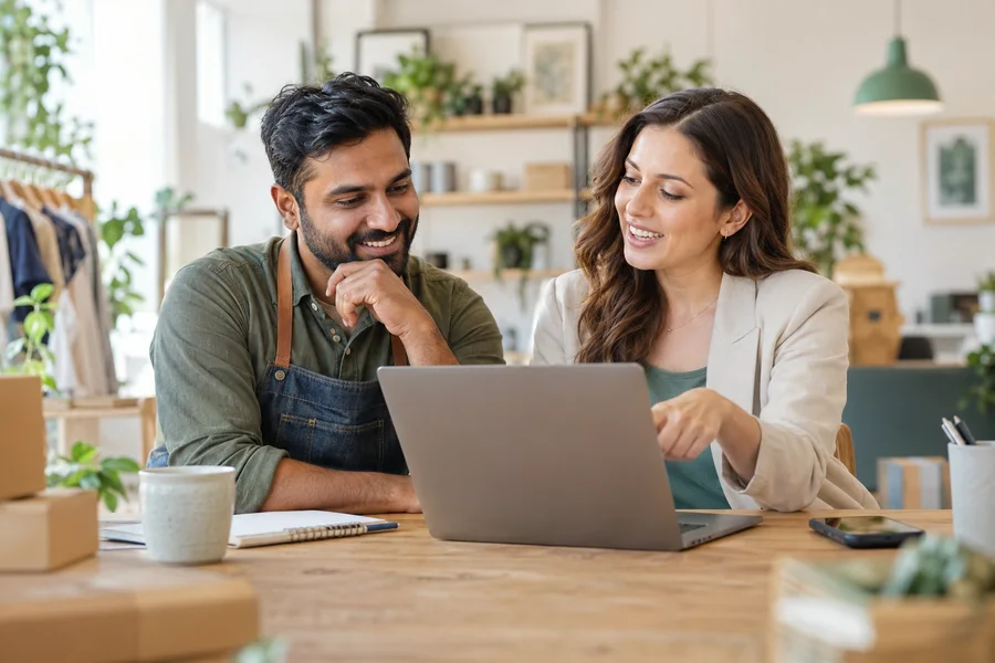 Smiling owner and advisor reviewing a store together